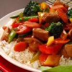 plate of pork stir fry with vegetables