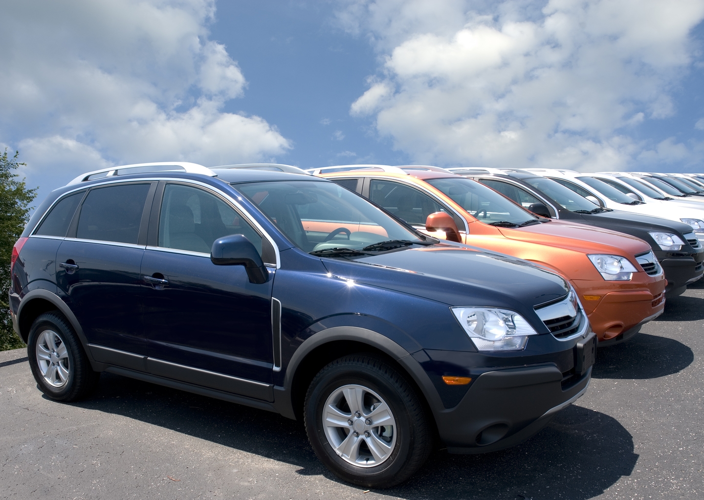500px Photo ID: 98985513 - New fuel efficient SUV's on a car dealers lot for sale.